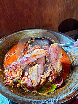 Cumi Balado or red chili squid. one of the typical Minangkabau dishes in Indonesia, fresh squid cooked with spicy chili sauce.