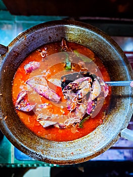 Cumi Balado or red chili squid. one of the typical Minangkabau dishes in Indonesia, fresh squid cooked with spicy chili sauce.