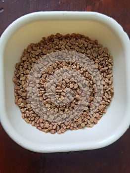 Cumin or caraway and fenugreek seeds isolated on black background. Top view