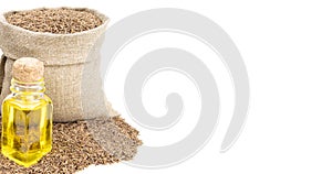 Cumin essential oil. Glass bottle of cummin oil. Caraway in a sack of isolated on a white background. Caraway in a burlap sack.