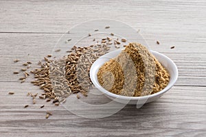 Cumin powder and seeds photo