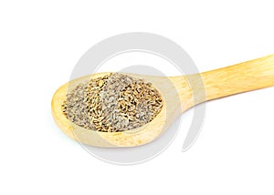 Cumin seeds isolated on wooden spoon over white background