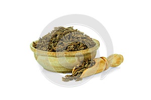 Cumin in a wooden cup with a spoon for spices isolated on a white background. Collection of spices and herbs
