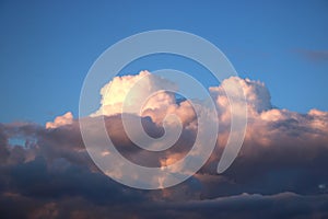 Cumulo-nimbus clouds pink at sunset and blue sky photo