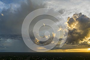 Cumulonimbus clouds forming before thunderstorm on evening sky. Changing stormy cloudscape weather at sunset