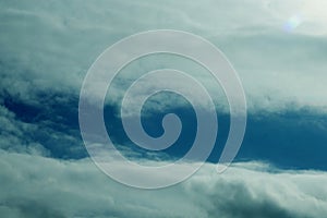 Cumulonimbus clouds with the sun in parallel .