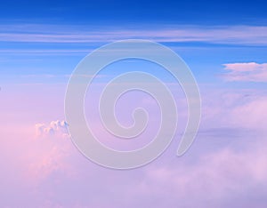 Cumulonimbus and Stratiform Clouds in Infinite Blue Sky with Shades of Pink - Aerial View - Abstract Natural Background