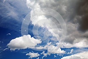 Cumulus and cirrus clouds against a blue sky