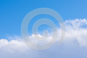 Cumulus clouds from above in sunny blue summer sky