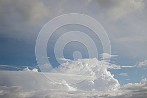 Cumulus clouds with a clear blue sky background in the midday.