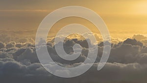 Cumulus clouds in the morning sunlight. White clouds and orange sky.