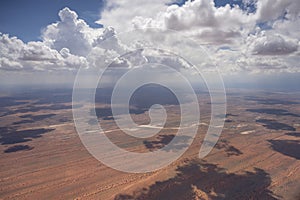 cumulus clouds and rain shower on dune stripes of Kalahari, east of Pokweni, Namibia