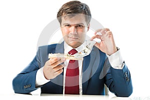 Cunning businessman taking dollar bill out of mousetrap