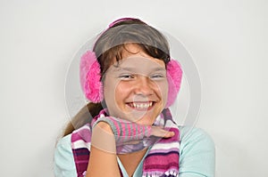 A cunning girl with ear muffs and trimmed gloves photo