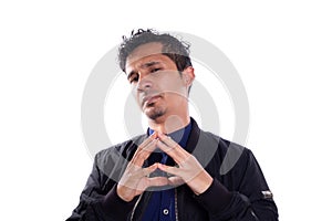 Cunning man plotting something isolated on white background. Young adult Latino man expressing evil or desire for