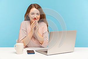 Cunning woman employee with tricky face scheming and conspiring sitting at workplace in office, thinking sly plan