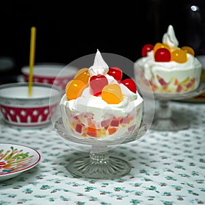 A cup of ambrosia salad with fruits