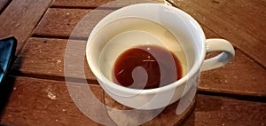 A cup of arabican coffee on the wooden table