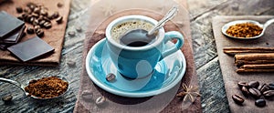 A cup of aromatic black coffee, a coffee maker, coffee beans of different varieties on the table. Morning espresso or Americano photo