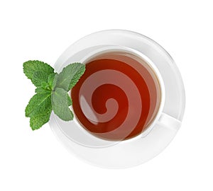Cup of aromatic black tea with fresh mint on white background, top view