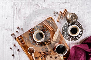 Cup of aromatic coffee drink and coffee beans on wooden background. Top view