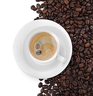 Cup with aromatic coffee and pile of beans on white background, top view