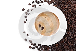 Cup with aromatic coffee and pile of beans on white background, top view