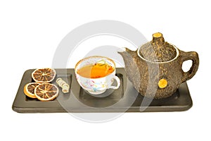 Cup of aromatic tea and teapot isolated