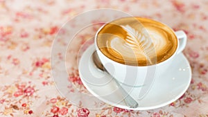 Cup of art latte or cappuccino coffee with retro filter effect a