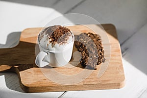 Cup of Babyccino with dark chocolate cookies photo