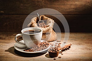 A cup of black coffee or americano with roasted coffee bean in b