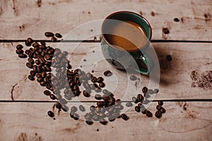 Cup of black coffee with beans