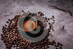 Cup of black coffee with beans