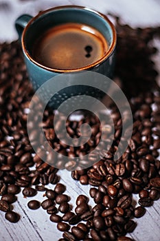 Cup of black coffee with beans