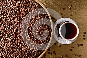 Cup of black coffee and beans