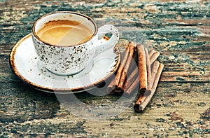 Cup of black coffee with cinnamon spices. Creative food