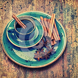 Cup of black coffee with cinnamon and star anise spices