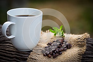 Cup of black coffee and coffee beans