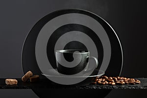 Cup of black coffee with coffee beans and brown sugar