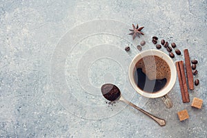 Cup of black coffee , coffee beans, brown sugar and cinnamon