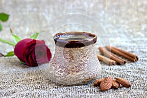 Cup of black coffee with coffee beans, red rose .