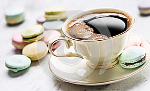 Cup of black coffee with french macaroons