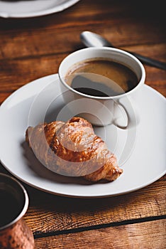 Cup of Black Coffee and Fresh Croissant