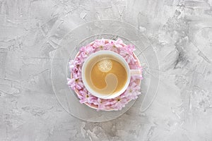 Cup of black coffee and fresh pink flowers