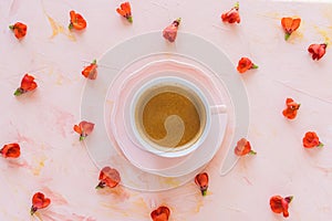 Cup of black coffee and fresh red flowers