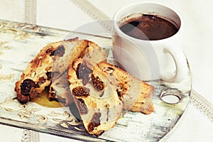 Cup of black coffee and homemade cookies biscotti on linen tablecloth. Selective focus. Retro toned.