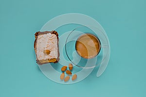 Cup of black coffee with merinque cake and almond