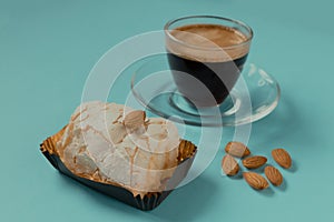 Cup of black coffee with merinque cake and almond