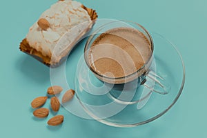 Cup of black coffee with merinque cake and almond