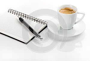 Cup of black coffee and note book